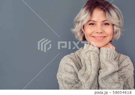 Young woman in a woolen sweater isolated on grey wall winter concept warmth Young woman in a woolen sweater isolated on grey wall winter concept warmth 59054618