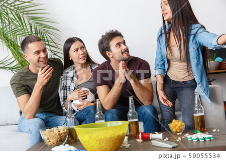 Group of friends sport fans watching football match listening to talk Group of friends sport fans watching football match listening to talk 59055534