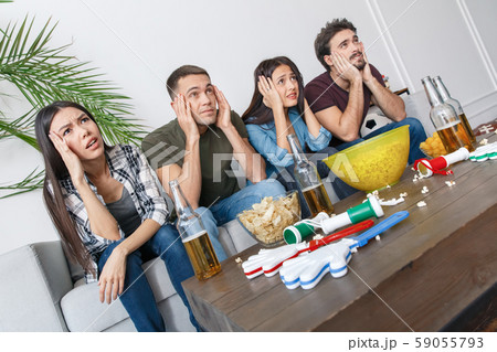 Group of friends sport fans watching soccer match holding head 59055793