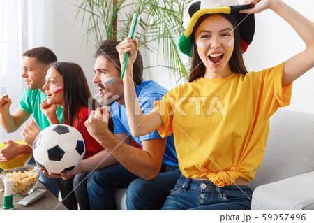 Group of friends sport fans watching match in colorful shirts girl screaming cheerful 59057496