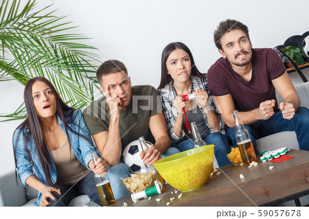 Group of friends sport fans watching match nervous Group of friends sport fans watching match nervous 59057678