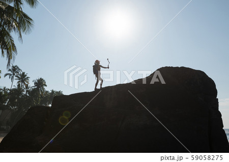 Woman Hiker taking selfie with Action Camera Woman Hiker taking selfie with Action Camera 59058275