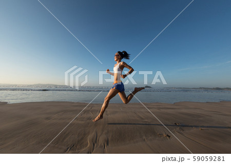 young fitness woman running at sunrise beach young fitness woman running at sunrise beach 59059281