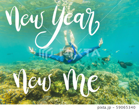 NEW YEAR NEW ME concept Happy woman in snorkeling mask dive underwater with tropical fishes in coral 59065340