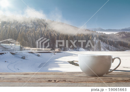 Single tea or coffee cup and landscape of mountains on background 59065663
