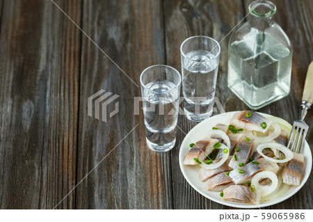 Vodka and traditional snack on wooden background Vodka and traditional snack on wooden background 59065986