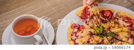 Woman eating delicious strawberry pizza on a balinese tropical nature background. Bali island Woman eating delicious strawberry pizza on a balinese tropical nature background. Bali island 59066174