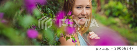 Young woman tourist in Bali walks along the narrow cozy streets of Ubud. Bali is a popular tourist 59066247