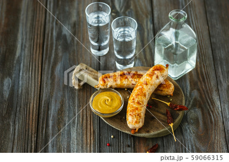 Vodka and traditional snack on wooden background 59066315