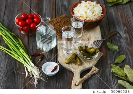 Vodka and traditional snack on wooden background 59066588