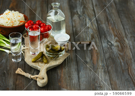 Vodka and traditional snack on wooden background 59066599
