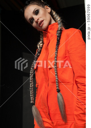 portrait of a beautiful woman in working orange clothes portrait of a beautiful woman in working orange clothes 59067099