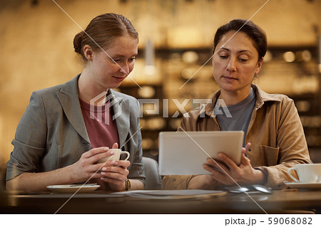 Businesswomen using digital tablet 59068082