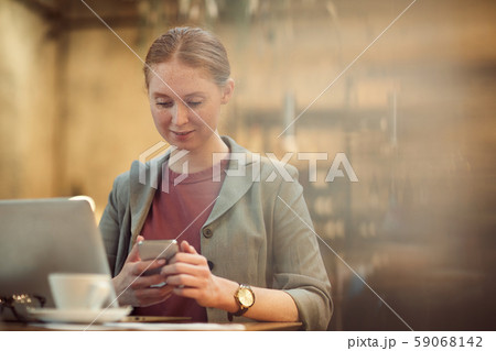 Businesswoman working in cafe 59068142