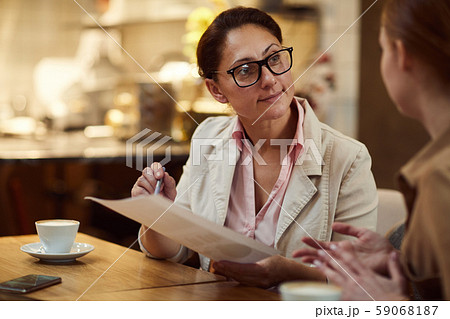 Women discussing contract at meeting 59068187