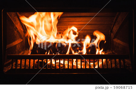Burning firewood in a fireplace Burning firewood in a fireplace 59068715