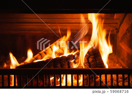 Firewood burning in a fireplace Firewood burning in a fireplace 59068716