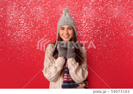 Freestyle. Young woman wearing scarf and hat standing isolated on red making heart with hands Freestyle. Young woman wearing scarf and hat standing isolated on red making heart with hands 59073183