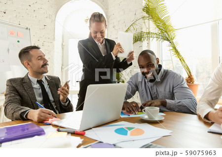Group of young business professionals having a meeting, creative office Group of young business professionals having a meeting, creative office 59075963