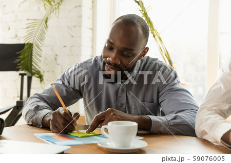 Young business professional preparing for meeting, creative office Young business professional preparing for meeting, creative office 59076005