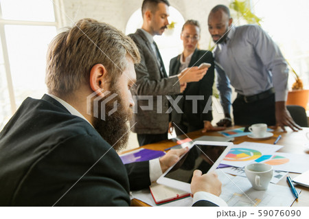 Group of young business professionals having a meeting, creative office Group of young business professionals having a meeting, creative office 59076090