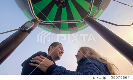 Adventure love couple on hot air balloon watermelon. Man and woman kiss hug love each other. Burner 59079664