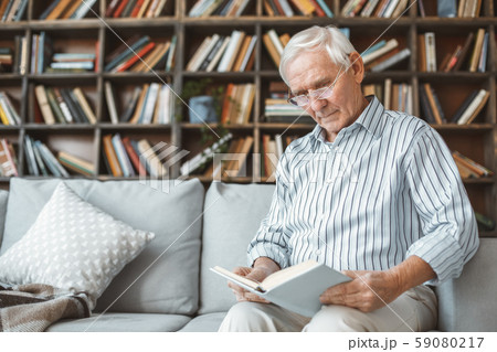 Senior man at home retirement concept sitting reading book 59080217