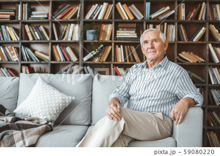 Senior man at home retirement concept sitting looking camera 59080220