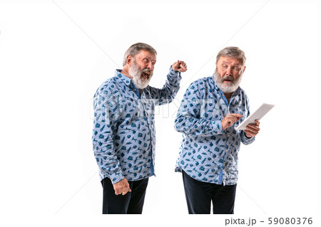 Senior man arguing with himself on white studio background. 59080376