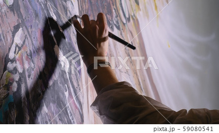 Artist designer draws an eagle on the wall. Craftsman decorator paints a picture with acrylic oil 59080541