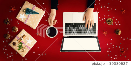 Christmas ornaments with person using a laptop computer 59080627