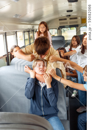 Classmates going to school by bus boy strangling kid punching aggressive Classmates going to school by bus boy strangling kid punching aggressive 59082066
