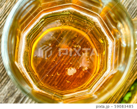 beer in a mug on top with bubbles 59083485