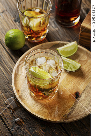 Strong golden rum with lime and ice Strong golden rum with lime and ice 59084327