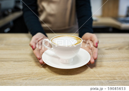 Barista brings fresh delicious coffee close up Barista brings fresh delicious coffee close up 59085653