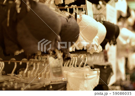 Bras on hangers and stands in white, black, milky color. 59086035