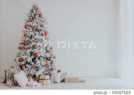 White room Christmas tree with red toys new year winter gifts decor White room Christmas tree with red toys new year winter gifts decor 59087889