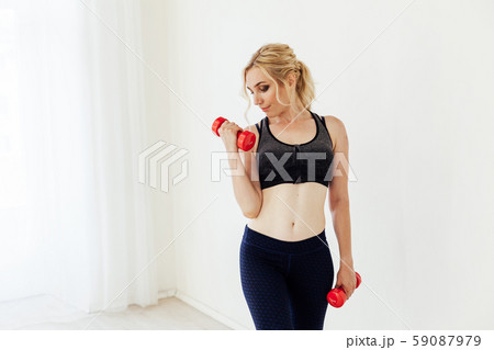 Blonde woman sports with fitness dumbbells life Blonde woman sports with fitness dumbbells life 59087979