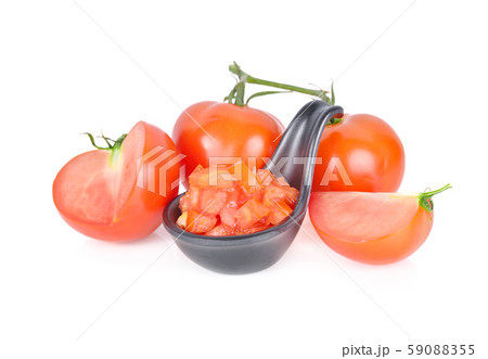 whole and cut cube tomato in black spoon and haf whole and cut cube tomato in black spoon and haf 59088355