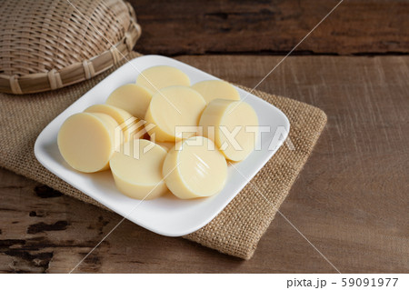 sliced of egg tofu in a ceramic dish on wooden table prepare to cook, close up. sliced of egg tofu in a ceramic dish on wooden table prepare to cook, close up. 59091977