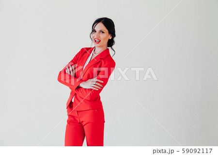 portrait of a beautiful woman in a red business suit in the office 59092117