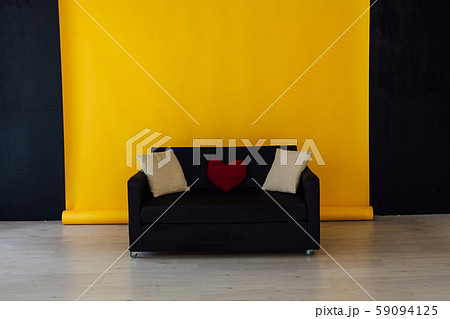 black office sofa in the interior of the room with a yellow background 59094125