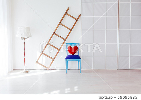 wooden staircase and chair in the interior of an empty white room 59095835