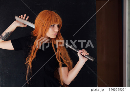 Girl cosplayer with red hair anime japan sword 59096394