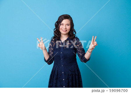 Portrait of a beautiful Asian woman shows four fingers Portrait of a beautiful Asian woman shows four fingers 59096700
