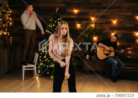 Cheerful beautiful young woman is dancing at the New Year party 59097225