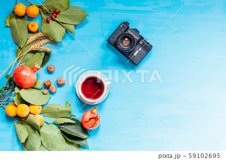 autumn fruits, nuts, pomegranate on blue background autumn fruits, nuts, pomegranate on blue background 59102695