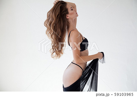 portrait of a beautiful woman in her underwear in a white room 59103965
