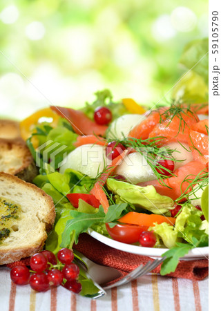 Summer salad with honeydew melon balls and smoked wild salmon 59105790