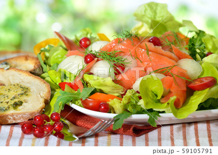 Summer salad with honeydew melon balls and smoked wild salmon 59105791